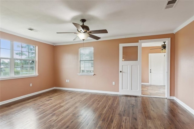 empty room with crown molding, wood-type flooring, and ceiling fan