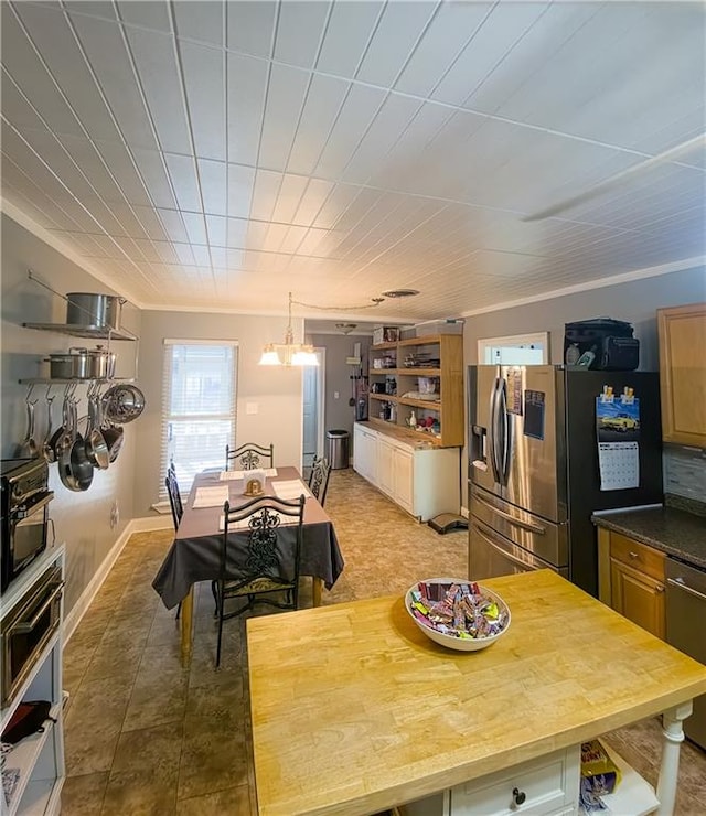 kitchen featuring appliances with stainless steel finishes and ornamental molding