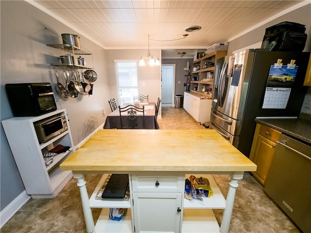 kitchen featuring white cabinetry, a chandelier, stainless steel appliances, and butcher block countertops