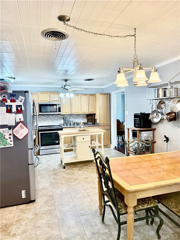 dining space featuring crown molding