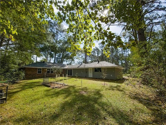 rear view of house with a lawn
