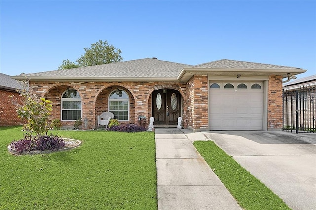 single story home with a garage and a front lawn