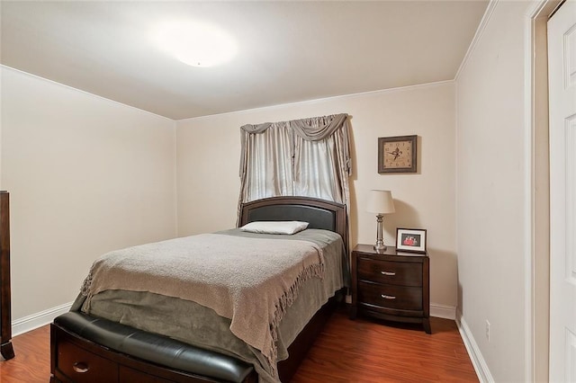 bedroom featuring crown molding and dark hardwood / wood-style flooring