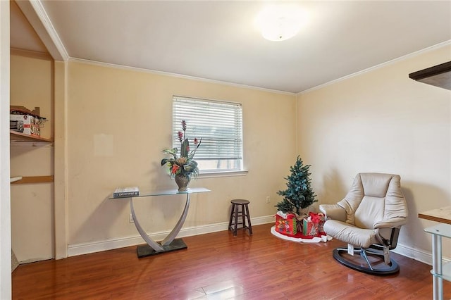 living area with crown molding and wood-type flooring