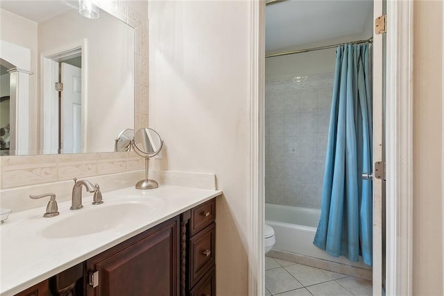 full bathroom featuring vanity, shower / bath combo with shower curtain, toilet, and tile patterned floors