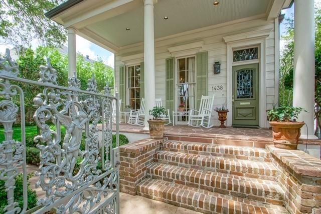 view of exterior entry featuring a porch