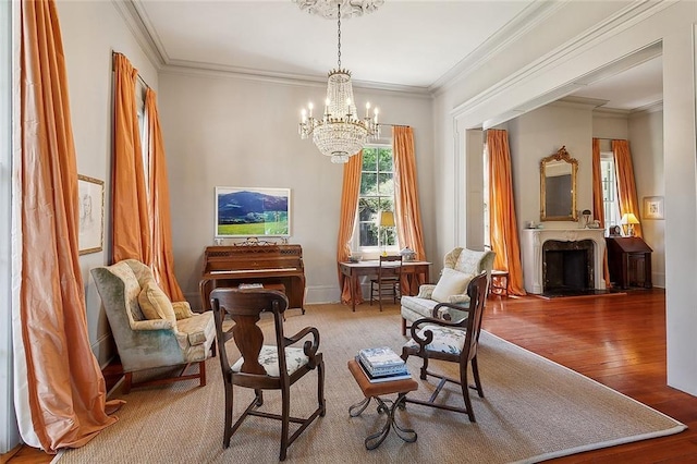 sitting room featuring an inviting chandelier, wood-type flooring, and crown molding