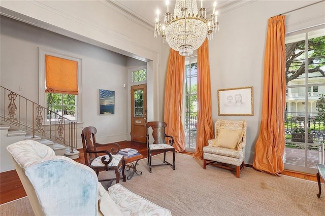 sitting room with a notable chandelier and ornamental molding