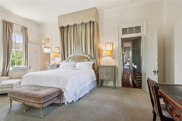 bedroom with ornamental molding and carpet