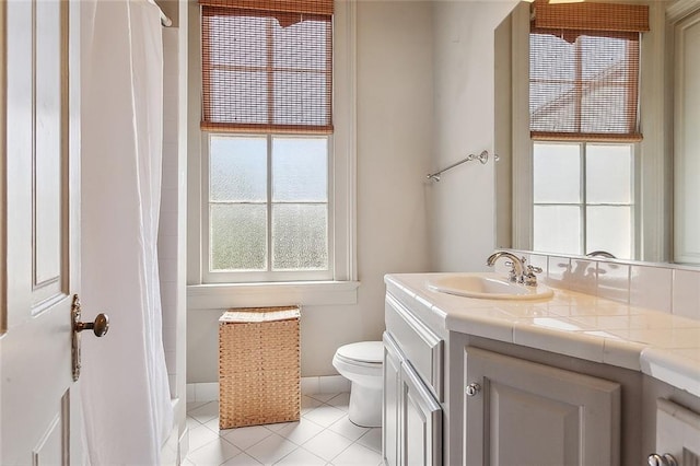 bathroom featuring tile patterned floors, vanity, and toilet