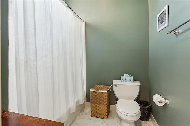 bathroom featuring tile patterned floors, toilet, and curtained shower