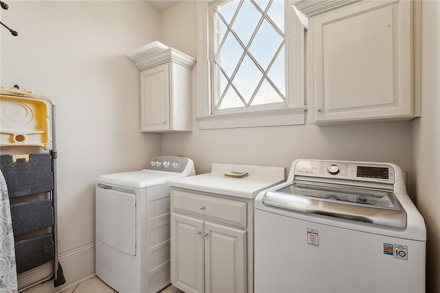 washroom featuring independent washer and dryer and cabinets