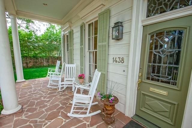 view of exterior entry featuring a porch