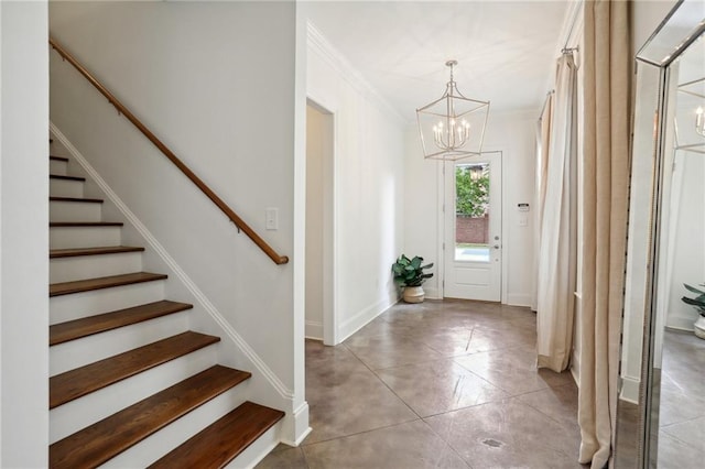 foyer entrance with crown molding, a notable chandelier, and light tile patterned floors