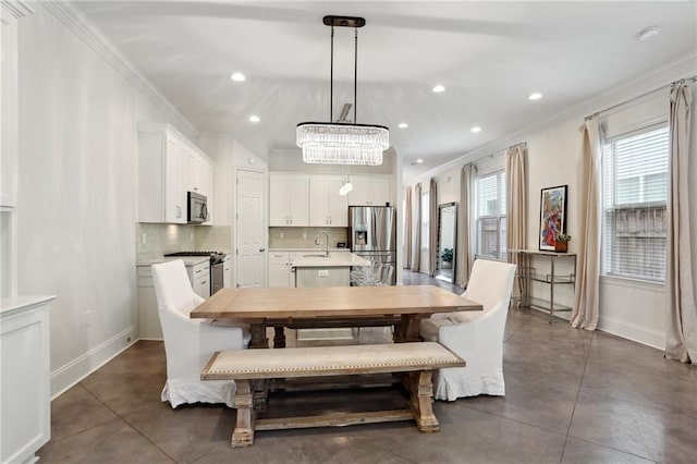 tiled dining room with ornamental molding and sink