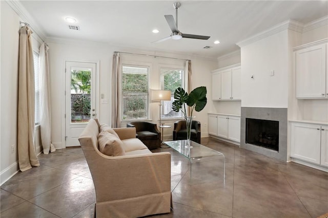 living room with ornamental molding, a fireplace, and ceiling fan