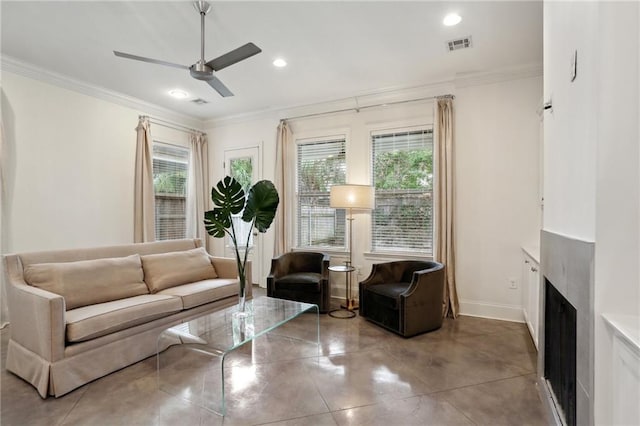 living room with ornamental molding and ceiling fan