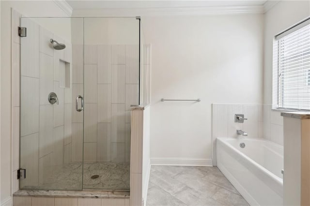 bathroom with ornamental molding and shower with separate bathtub