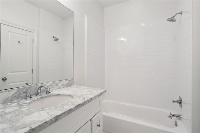 bathroom featuring vanity and tiled shower / bath combo