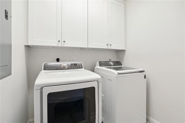 laundry room with independent washer and dryer and cabinets