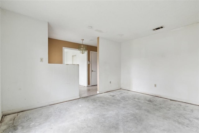 unfurnished room with an inviting chandelier