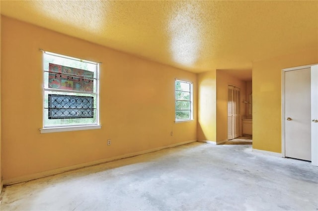 empty room featuring a textured ceiling