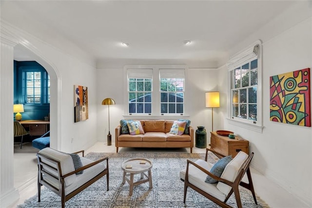 living area with a healthy amount of sunlight and light colored carpet