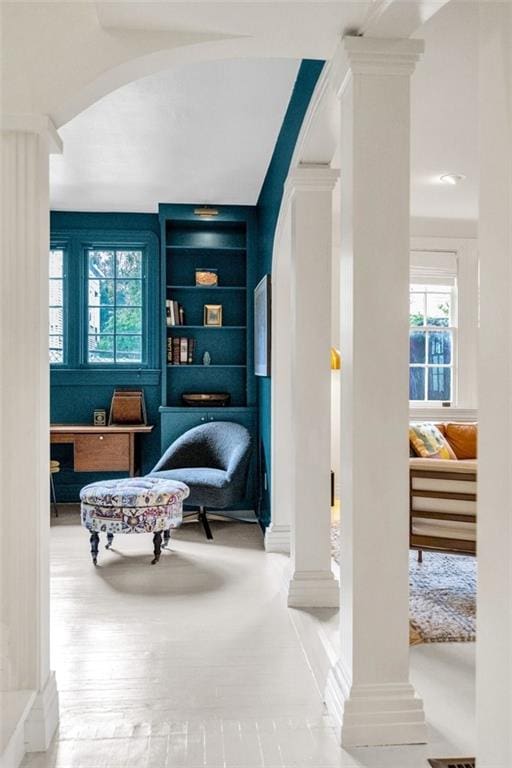 sitting room featuring decorative columns