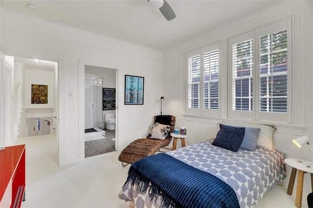 bedroom with ensuite bath, carpet flooring, and ceiling fan