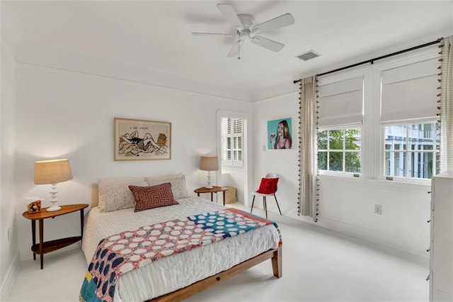 bedroom with ceiling fan and light carpet