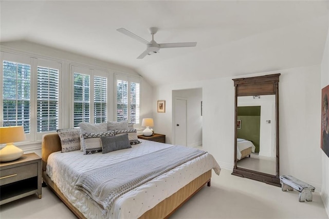 carpeted bedroom with vaulted ceiling, multiple windows, and ceiling fan