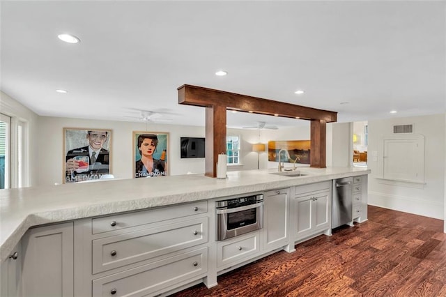 kitchen featuring appliances with stainless steel finishes, sink, and dark hardwood / wood-style flooring