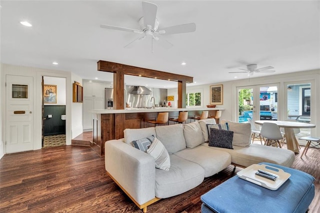 living room featuring ceiling fan and dark hardwood / wood-style flooring