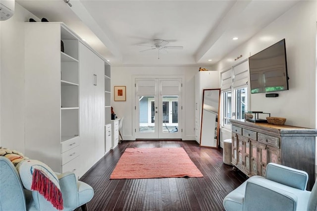 interior space featuring french doors, ceiling fan, a raised ceiling, and dark hardwood / wood-style flooring