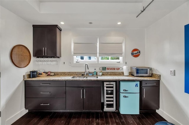 kitchen featuring sink, dark brown cabinetry, wine cooler, white refrigerator, and dark hardwood / wood-style floors