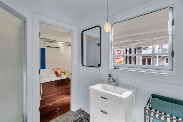 bathroom with vanity, hardwood / wood-style flooring, and a wall mounted air conditioner