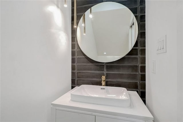 bathroom with vanity, tile walls, and decorative backsplash