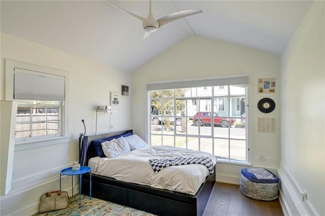 bedroom with multiple windows, wood-type flooring, and ceiling fan