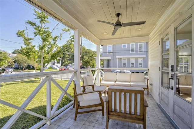 sunroom / solarium featuring wooden ceiling and ceiling fan