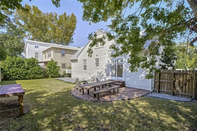 rear view of property with a patio area and a lawn