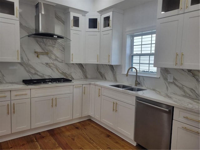 kitchen with wall chimney exhaust hood, white cabinetry, and appliances with stainless steel finishes