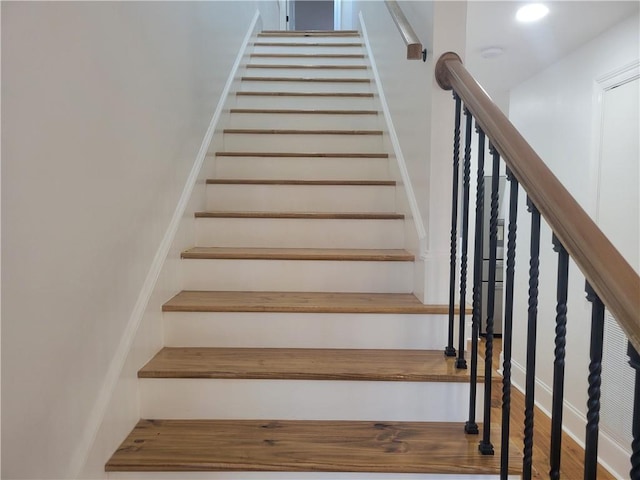 staircase featuring hardwood / wood-style flooring