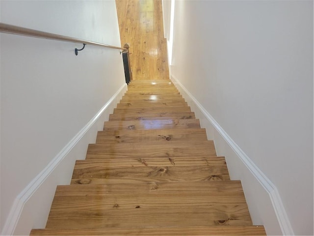 stairs with hardwood / wood-style flooring