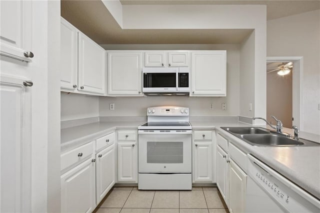 kitchen with white cabinets, white appliances, light tile patterned flooring, and sink