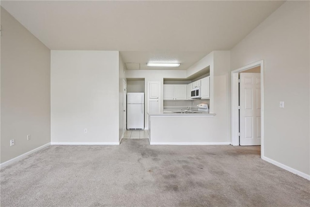 unfurnished living room featuring light colored carpet