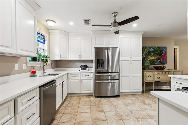 kitchen with ceiling fan, stainless steel appliances, sink, and white cabinets