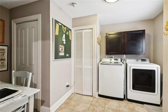 laundry room featuring cabinets, washer and dryer, and light tile patterned flooring