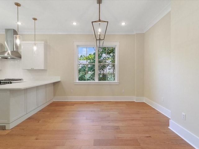 unfurnished dining area with light wood-style floors, recessed lighting, baseboards, and ornamental molding