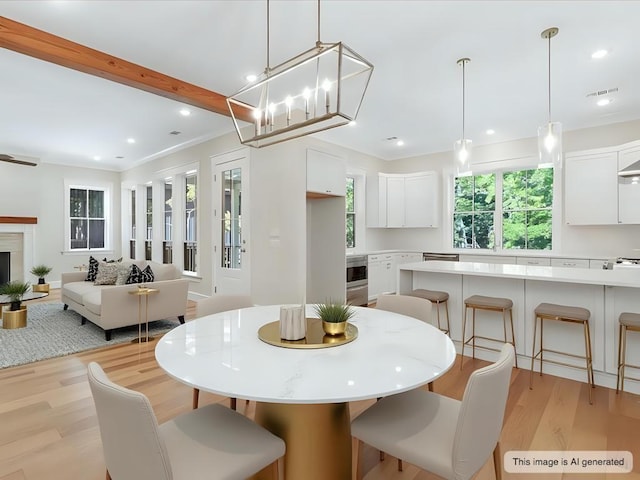 dining space with visible vents, a fireplace, light wood-style flooring, and recessed lighting