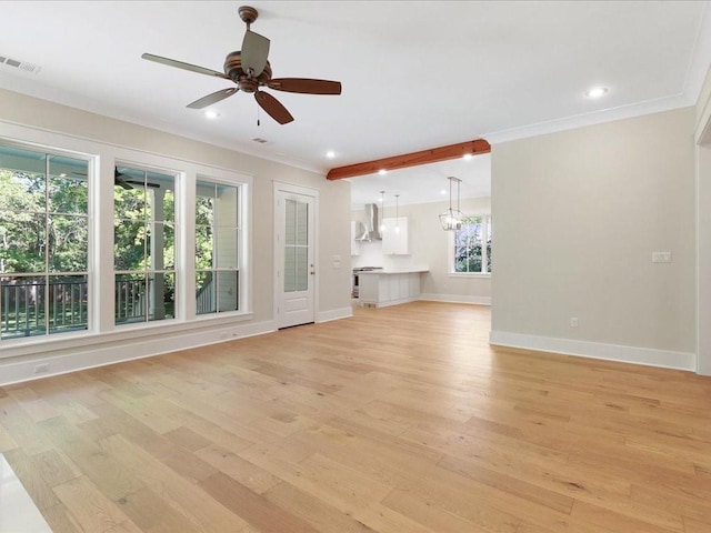 unfurnished living room featuring light wood-style flooring, ceiling fan with notable chandelier, visible vents, baseboards, and ornamental molding